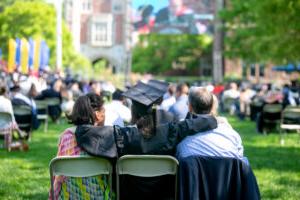 A 2021 Trinity College Graduate sitting with family